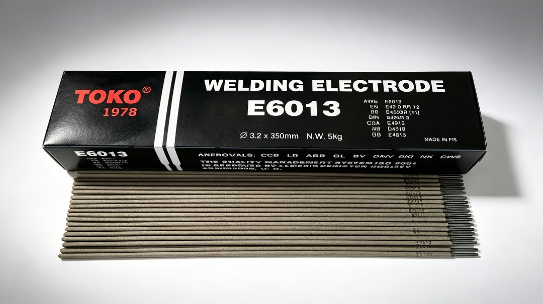 TOKO E6013 welding electrodes in box and on workbench
